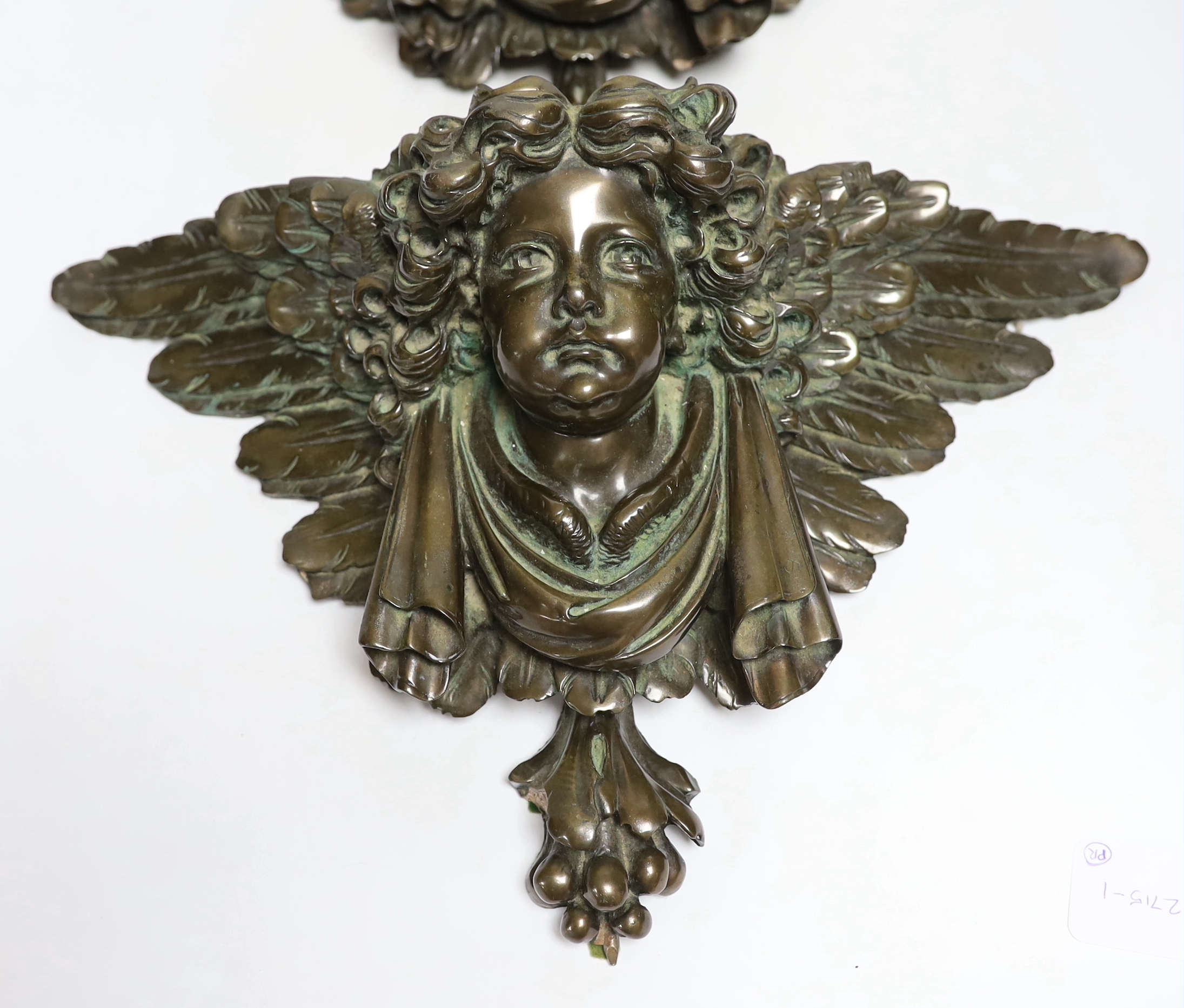 A pair of resin cherub brackets 'bronzed', 29 x 47cm